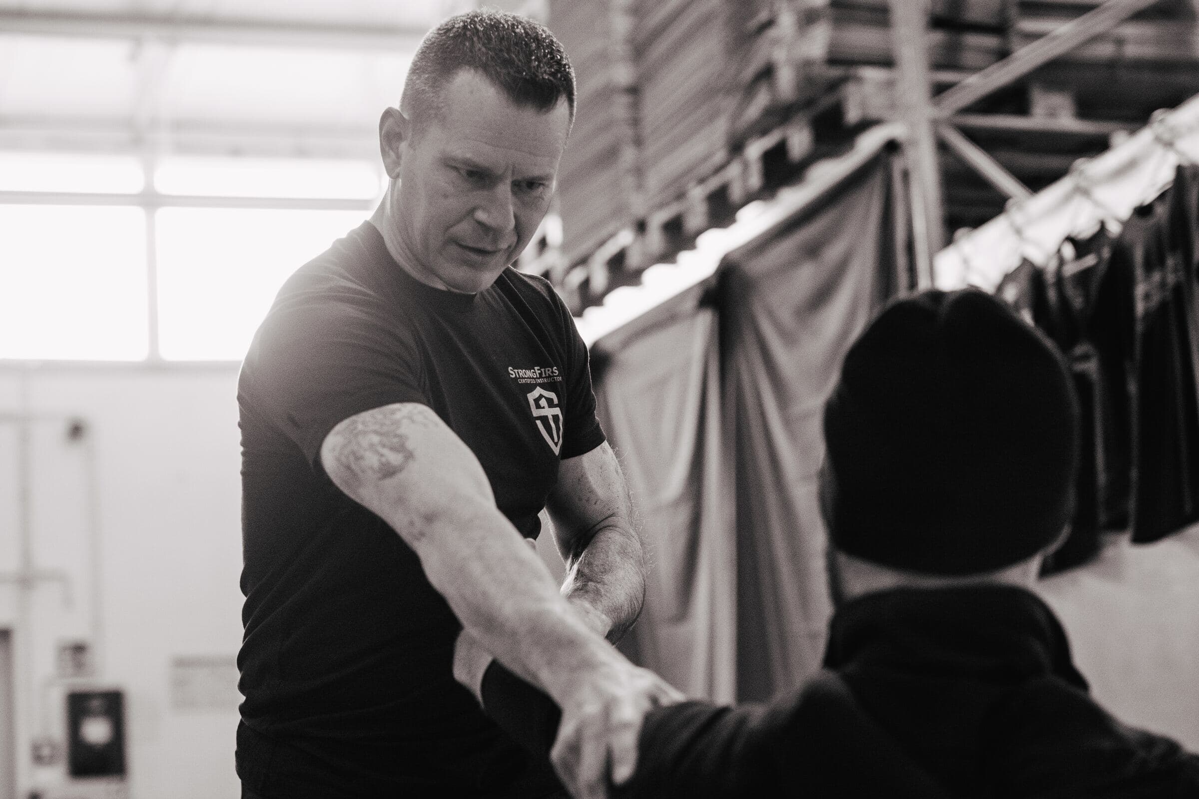 Kenneth Bolyard correcting a student's position hands-on