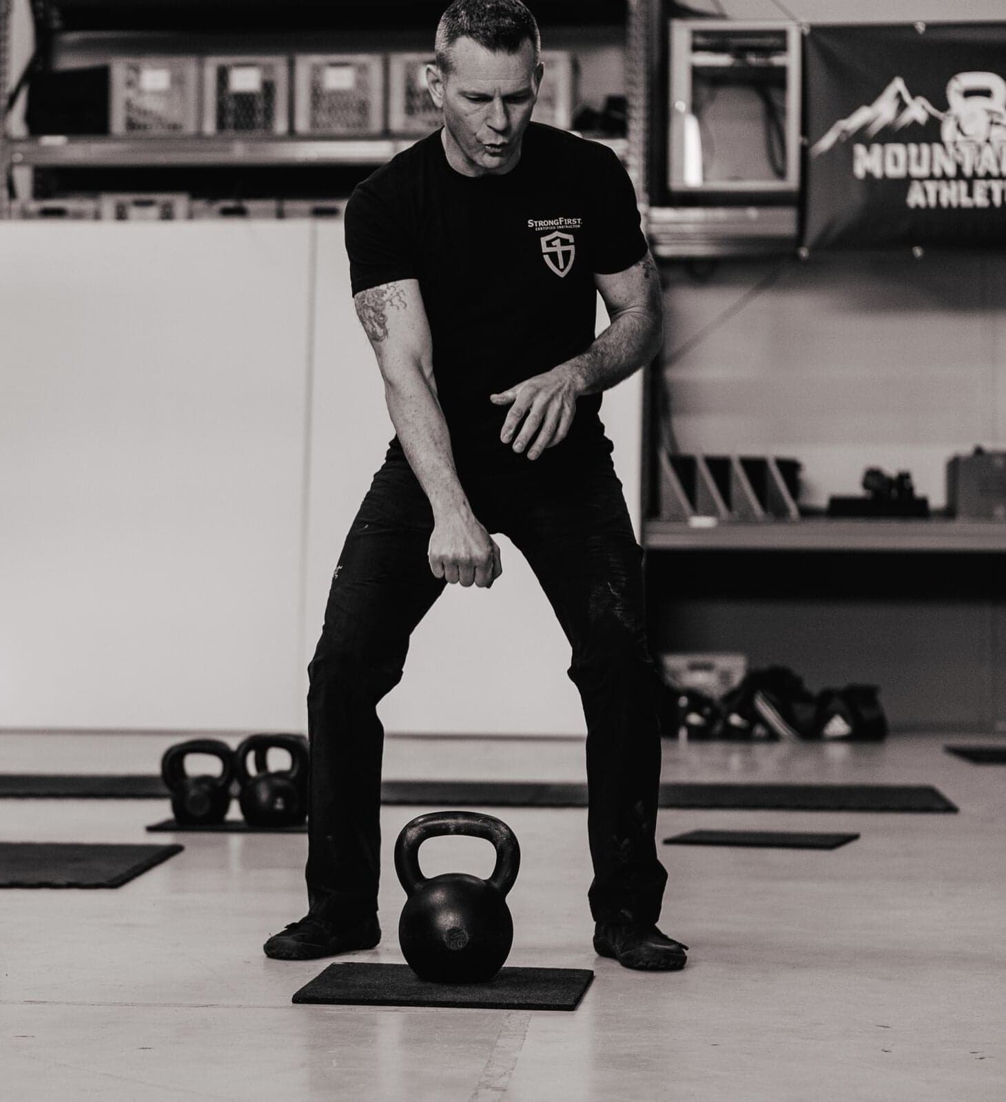 Kenneth Bolyard coaching a student through a kettlebell swing