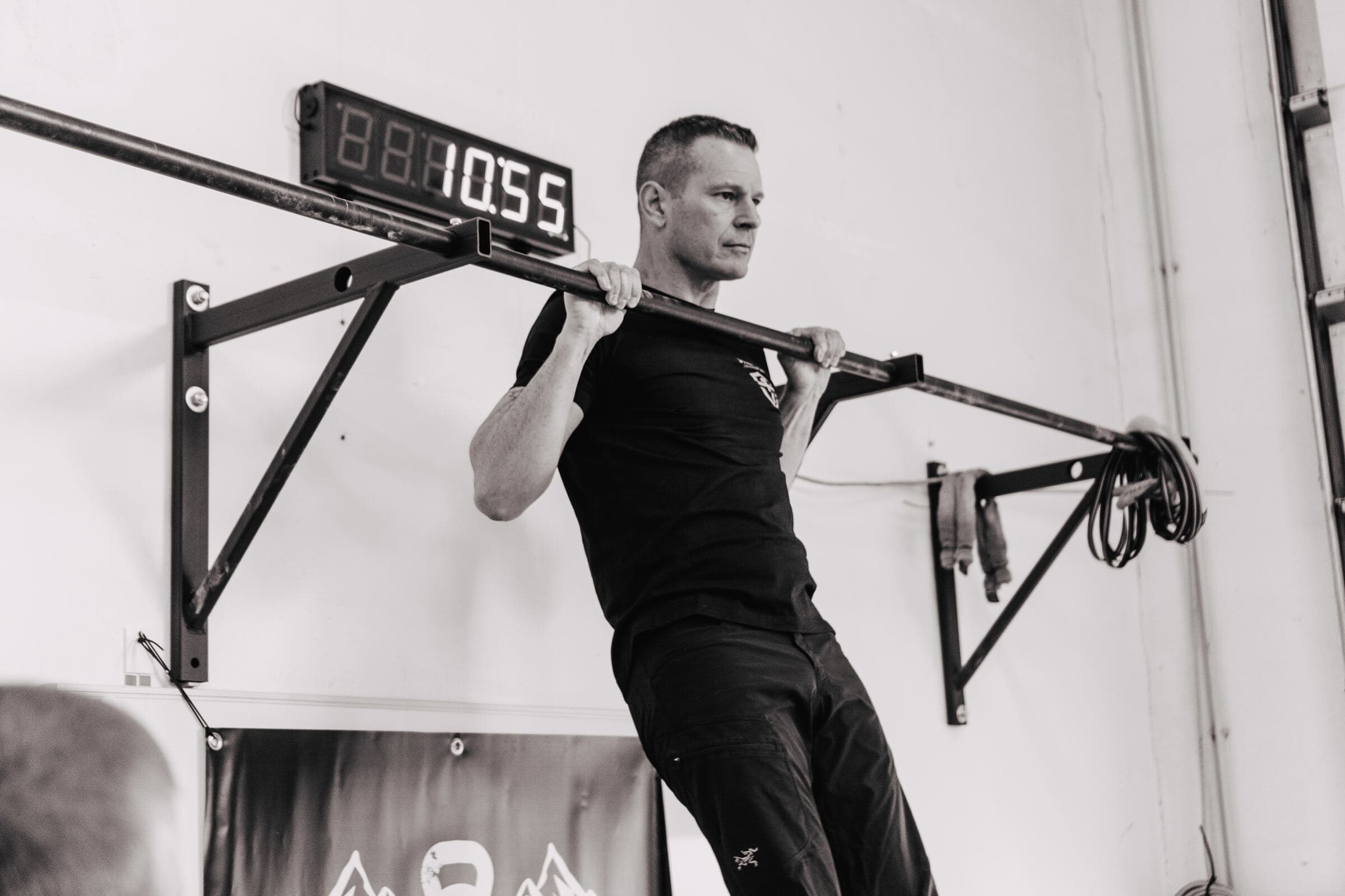 Athlete performing a pull-up during strength training.