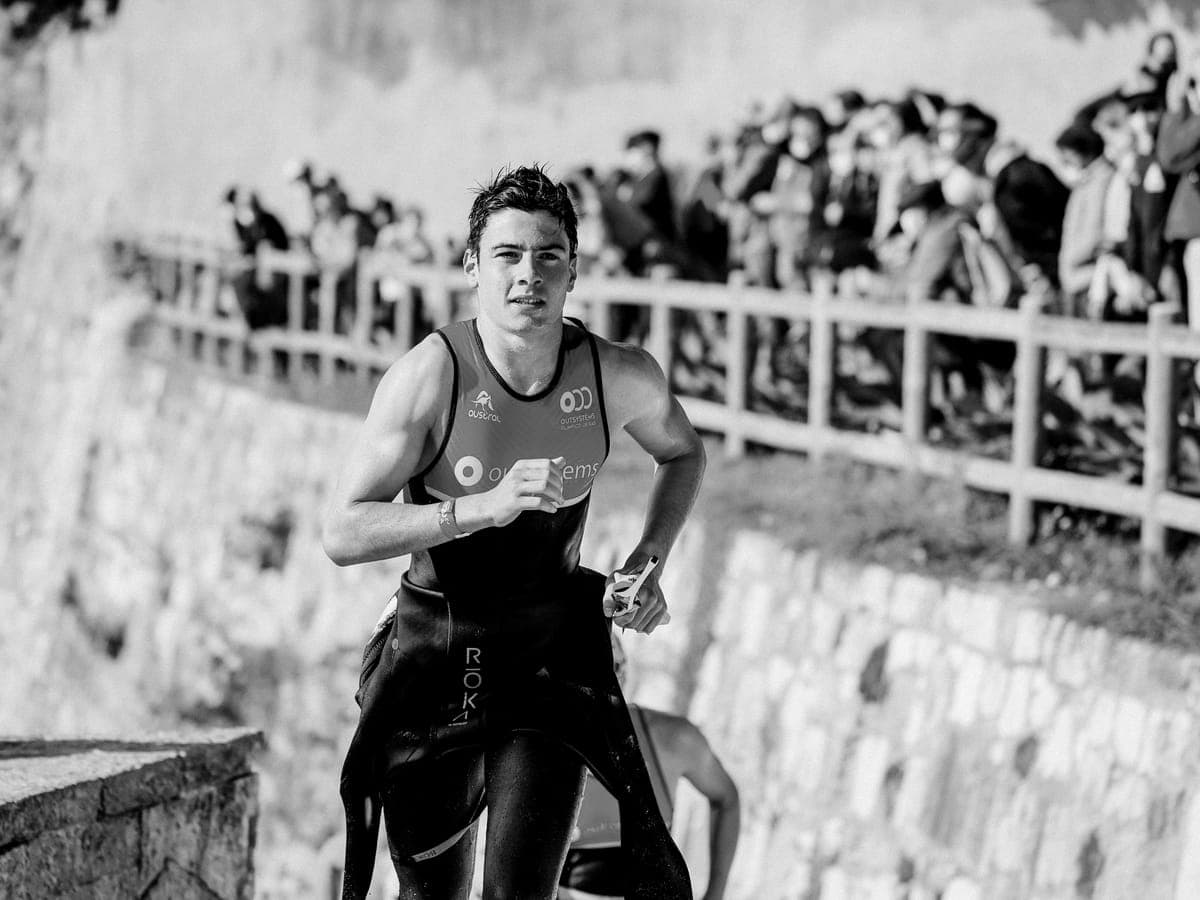 Triathlete running uphill during a race.